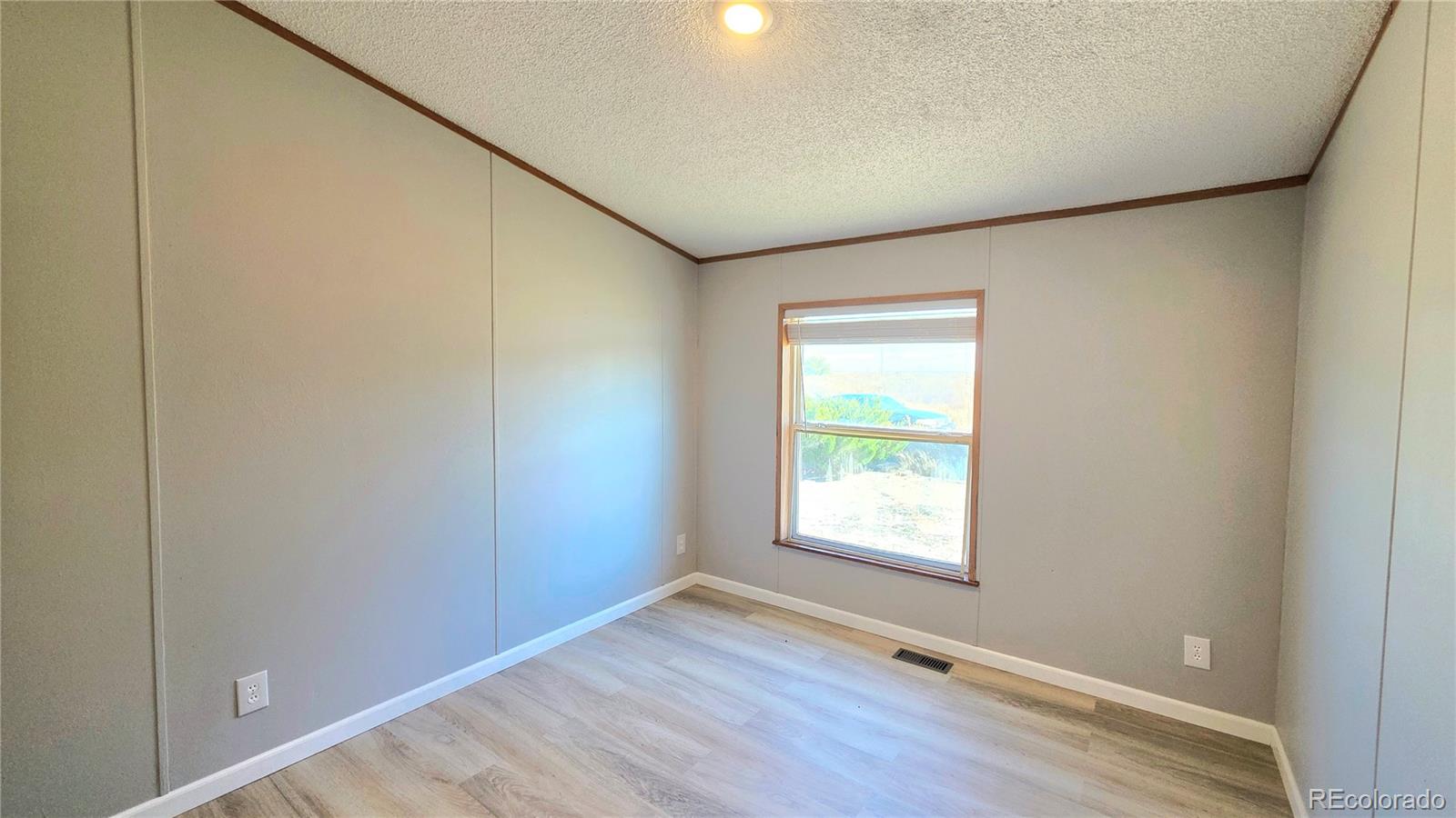 10754 County Road Olney Springs, CO 81062 - Photo 36 of 49 an empty room with wooden floor and windows