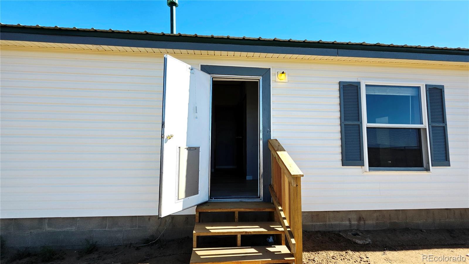 10754 County Road Olney Springs, CO 81062 - Photo 6 of 49 a front view of a house with a door
