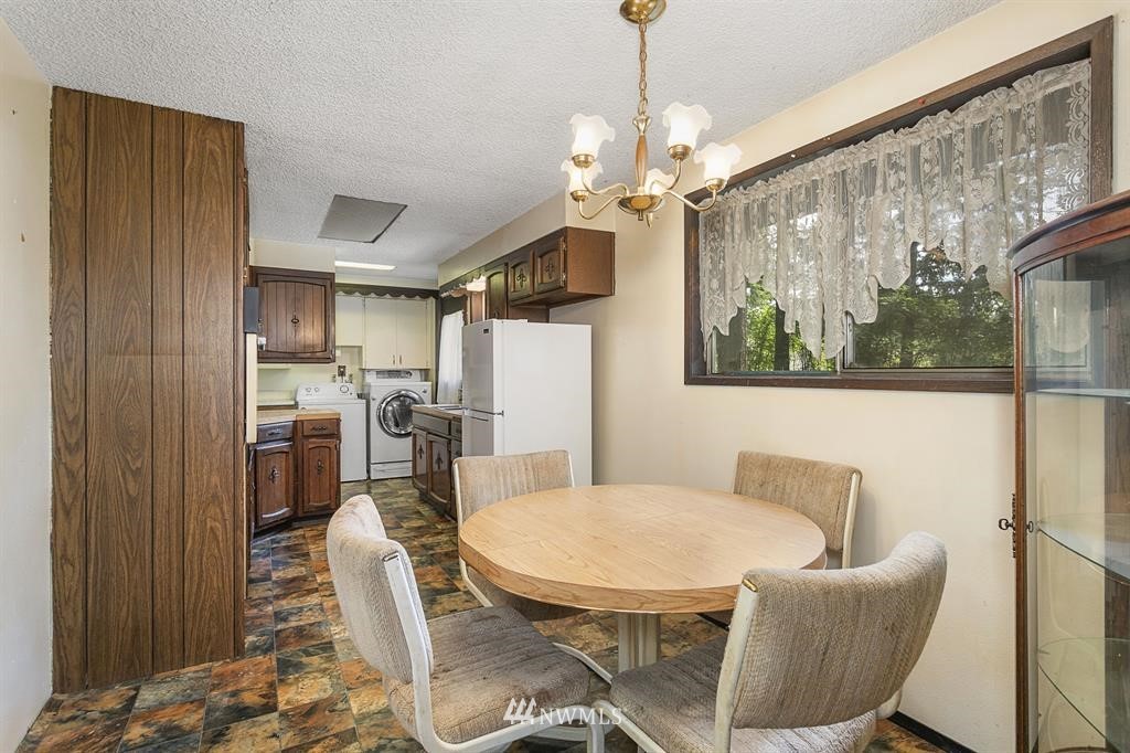 714 Ness' Corner Road Port Hadlock, WA 98339 - Photo 11 of 21 a view of a dining room with furniture window and wooden floor