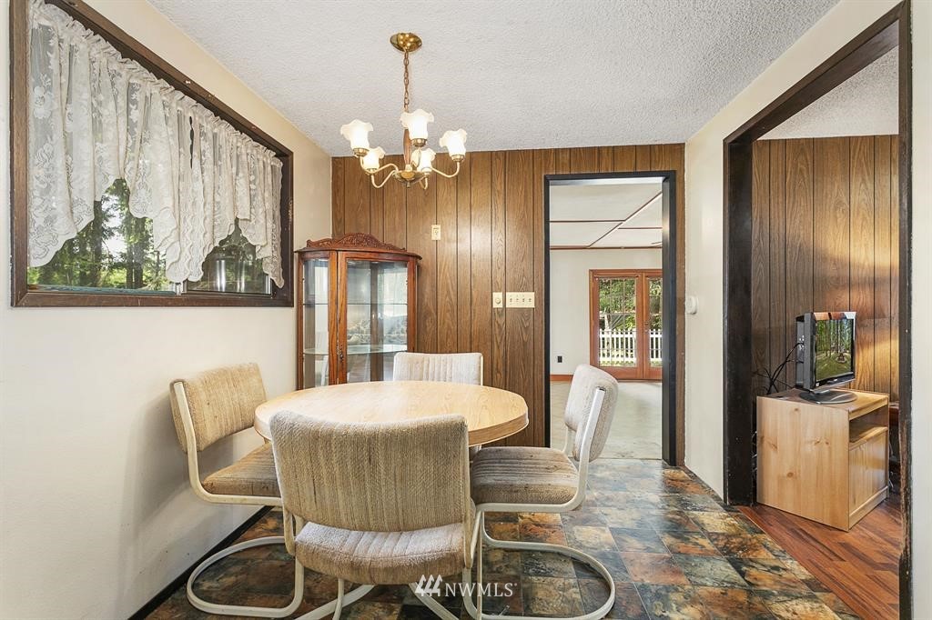 714 Ness' Corner Road Port Hadlock, WA 98339 - Photo 12 of 21 a view of a dining room with furniture window and wooden floor