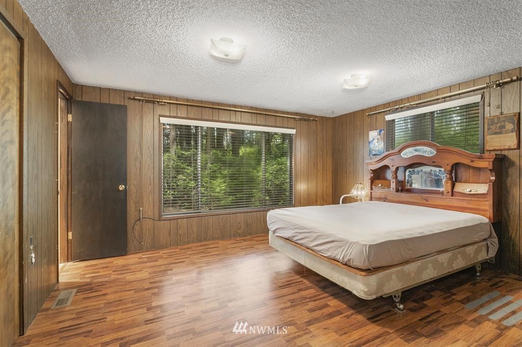 714 Ness' Corner Road Port Hadlock, WA 98339 - Photo 16 of 21 a bedroom with a large bed and a window