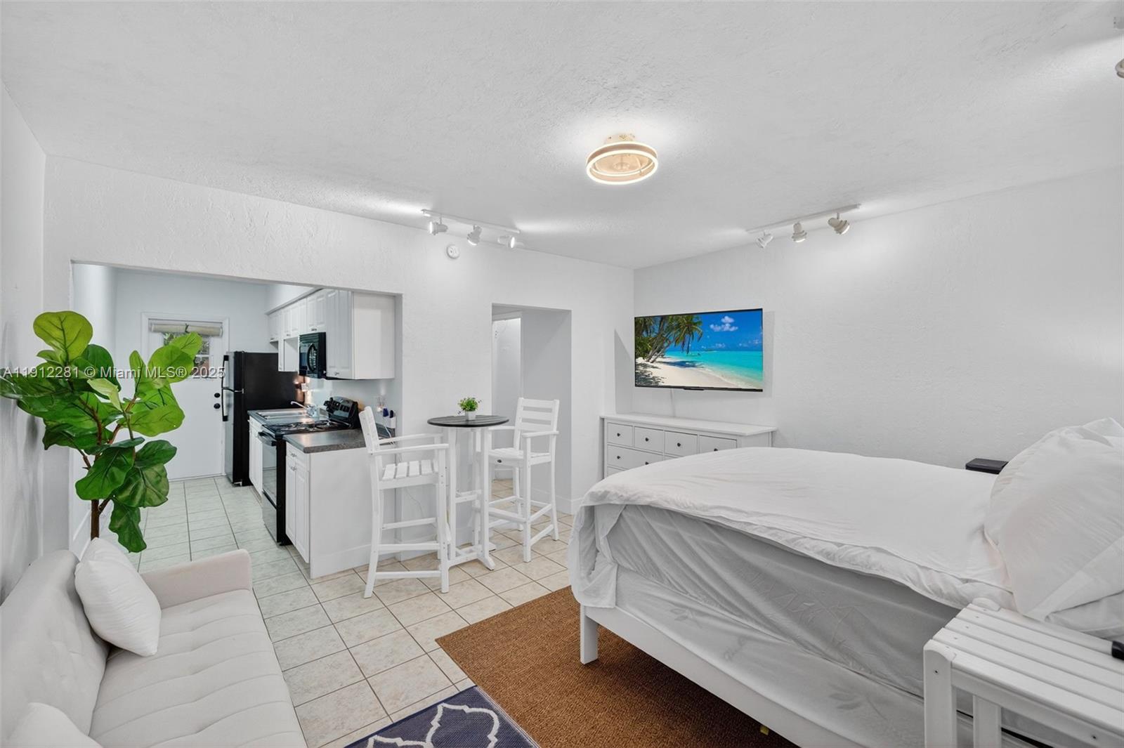 820 North Ocean Boulevard, Unit 1 Pompano Beach, FL 33062 - Photo 6 of 21 a bedroom with a bed and a couch