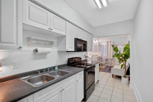 a kitchen that has a sink and a stove