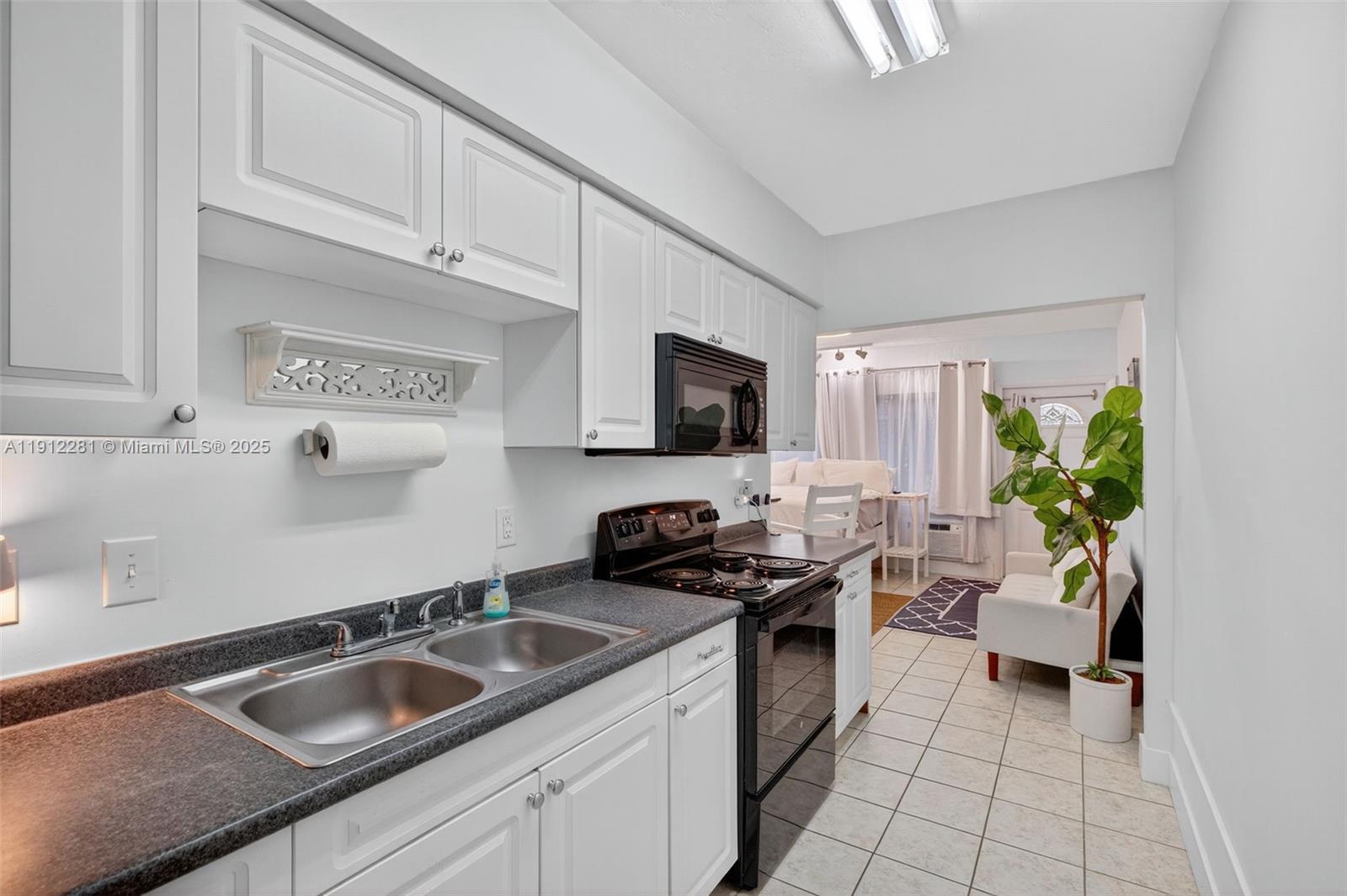 820 North Ocean Boulevard, Unit 1 Pompano Beach, FL 33062 - Photo 9 of 21 a kitchen that has a sink and a stove