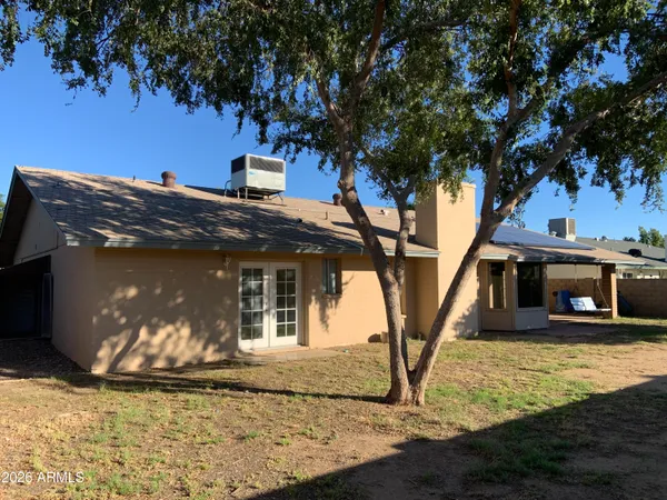 a view of a house with trees in the background