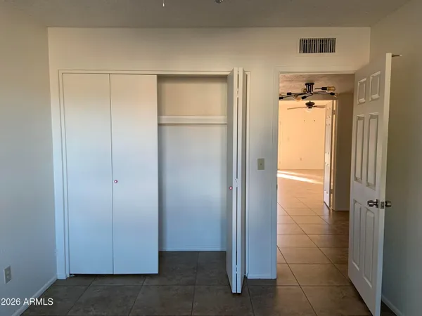 a view of a livingroom with wooden floor and a bathroom