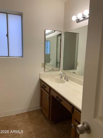 a bathroom with a sink vanity and a mirror