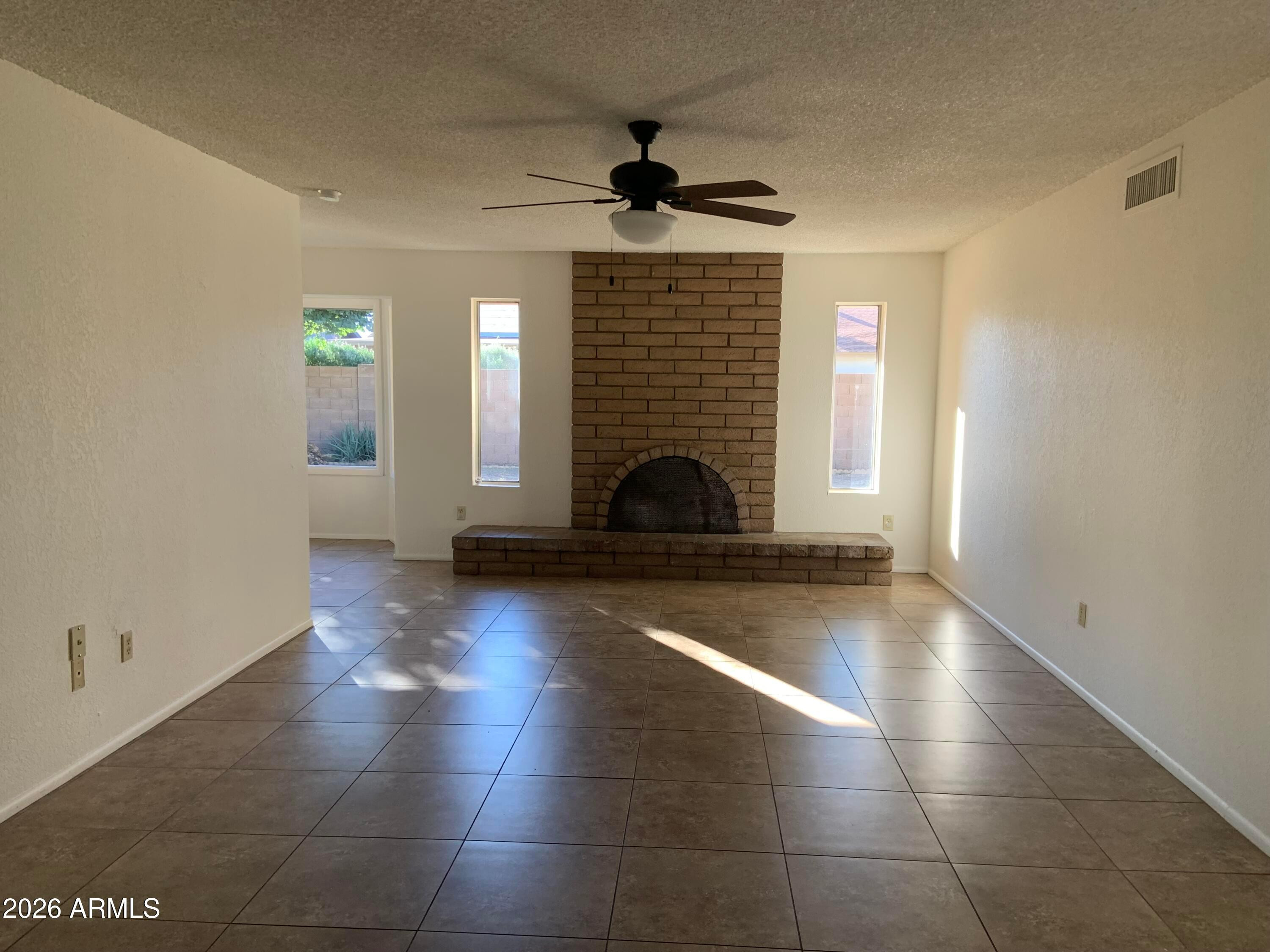 17634 North 2nd Street Phoenix, AZ 85022 - Photo 3 of 29 a view of a livingroom with wooden floor and a fireplace