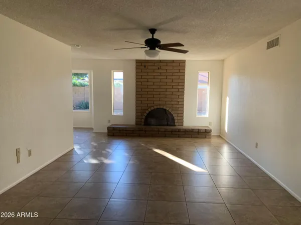 a view of a livingroom with wooden floor and a fireplace