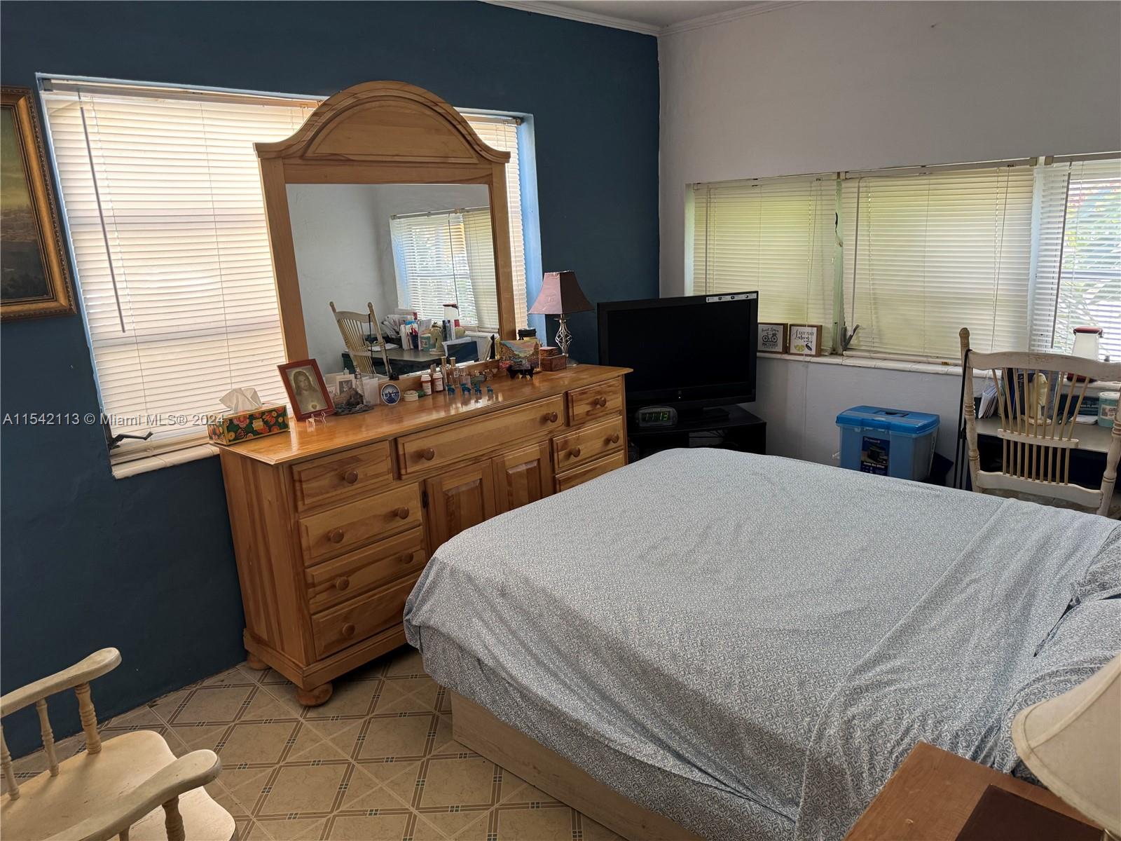 1854 Southwest 17th Street Miami, FL 33145 - Photo 11 of 13 a bedroom with a bed and a mirror