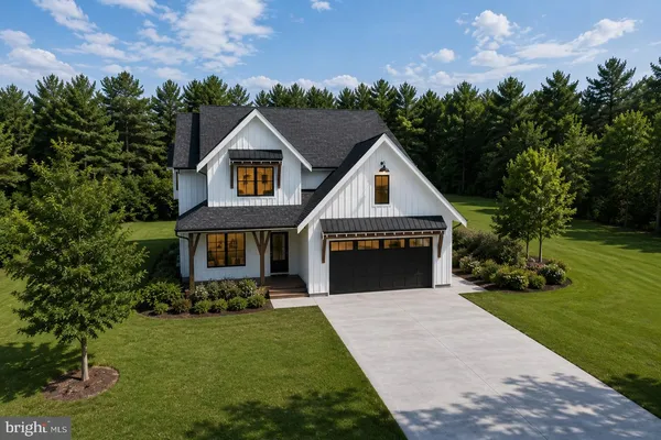 a view of house with yard and green space