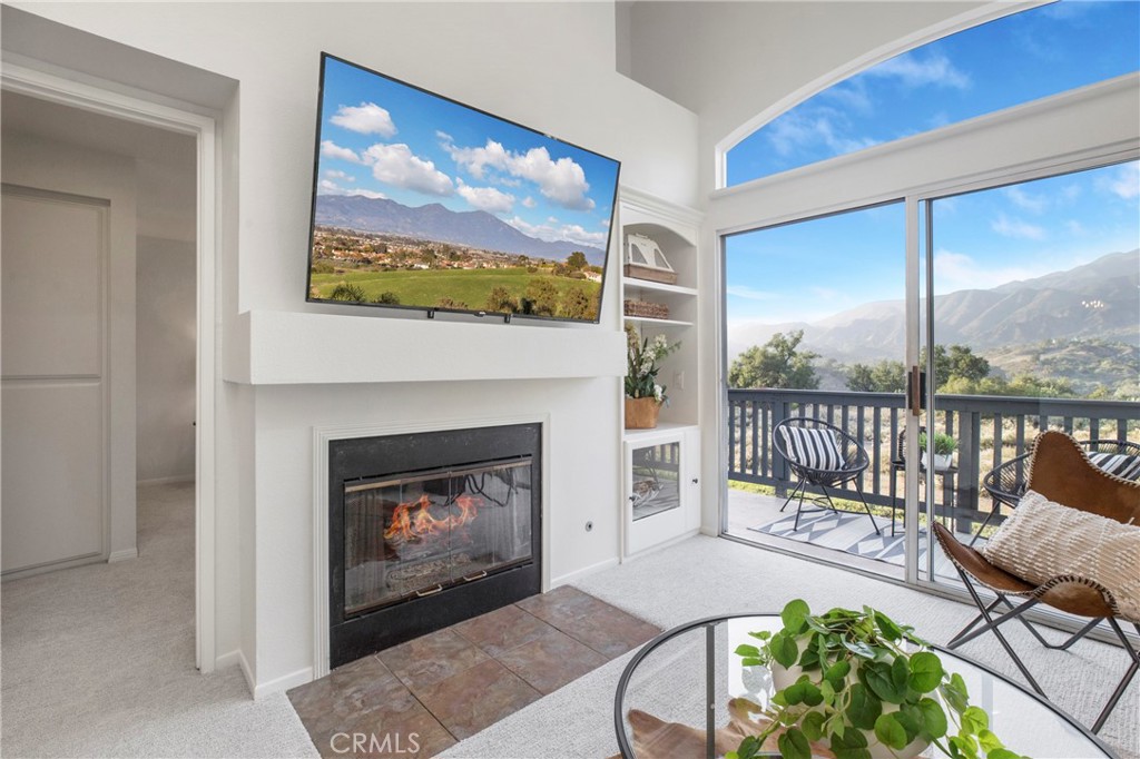 37 Lobelia Rancho Santa Margarita, CA 92688 - Photo 1 of 1 a living room with furniture a fireplace and a floor to ceiling window