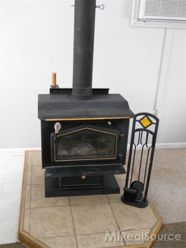 13850 Burt Road Capac, MI 48014 - Photo 8 of 23 This is a view of the wood stove in the living room.