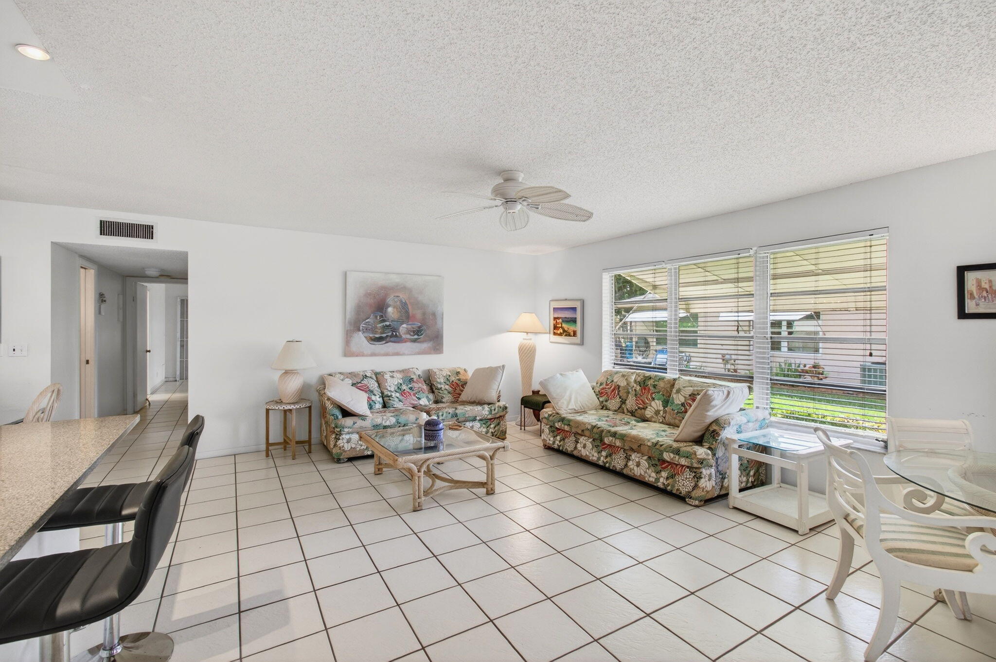1327 High Point Way Southeast, Unit D Delray Beach, FL 33445 - Photo 13 of 53 a living room with furniture and a floor to ceiling window
