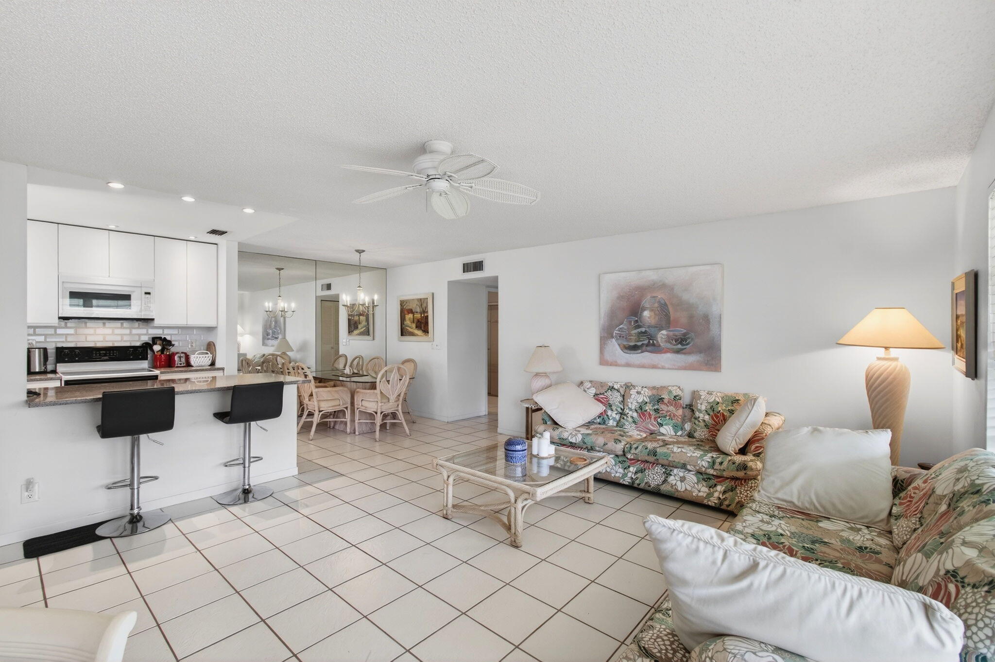 1327 High Point Way Southeast, Unit D Delray Beach, FL 33445 - Photo 16 of 53 a living room with furniture and kitchen view