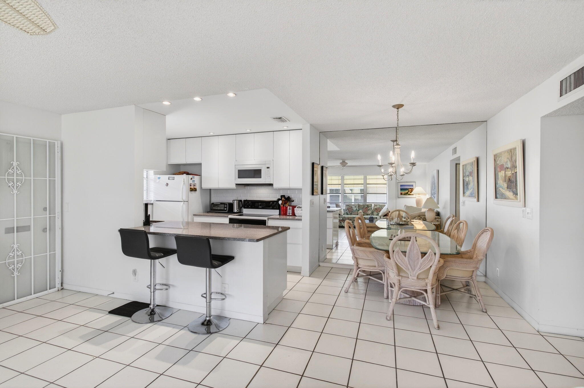 1327 High Point Way Southeast, Unit D Delray Beach, FL 33445 - Photo 23 of 53 a living room with furniture and view of kitchen appliances