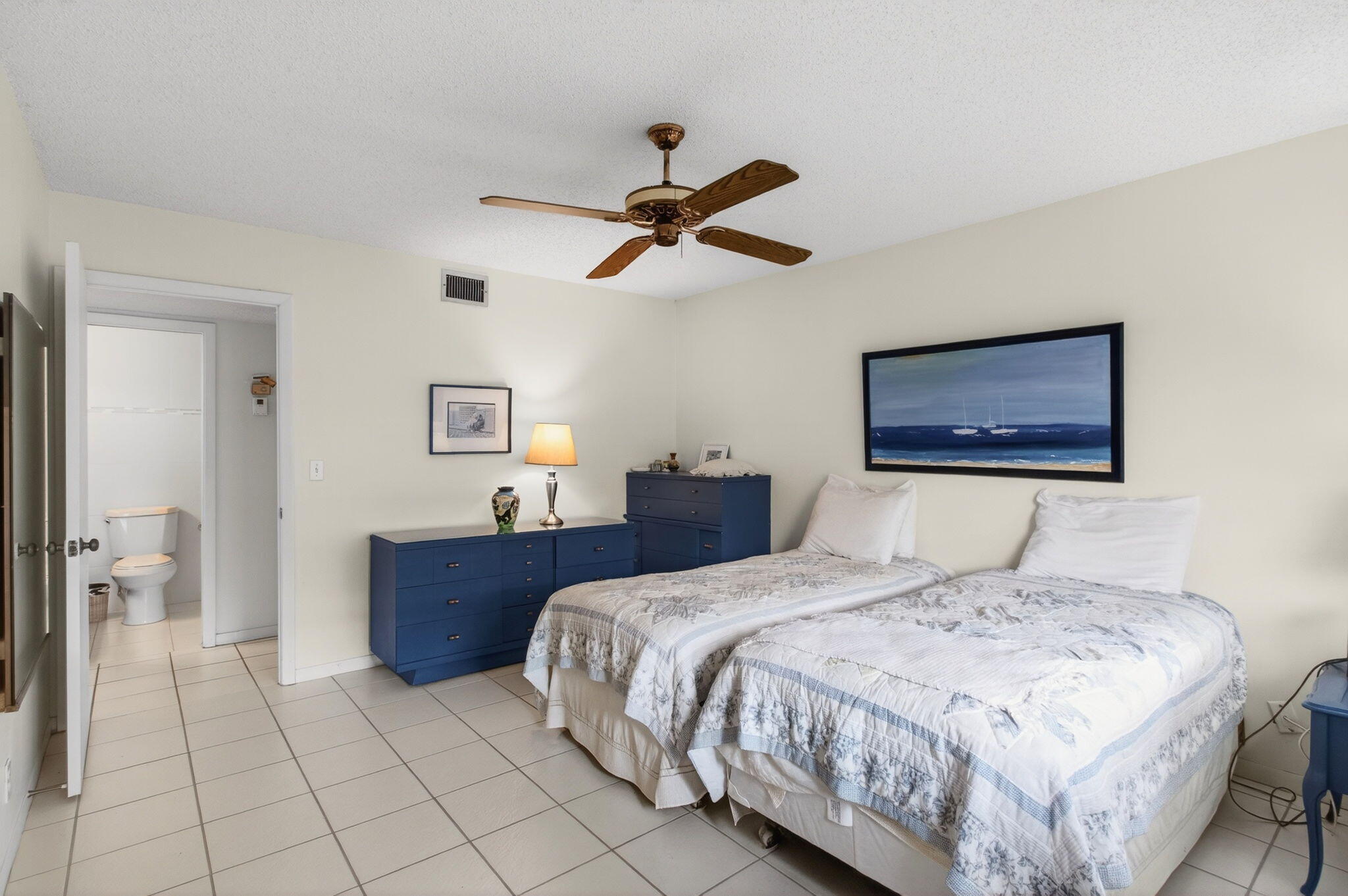 1327 High Point Way Southeast, Unit D Delray Beach, FL 33445 - Photo 26 of 53 a bedroom with a bed and a painting on the wall