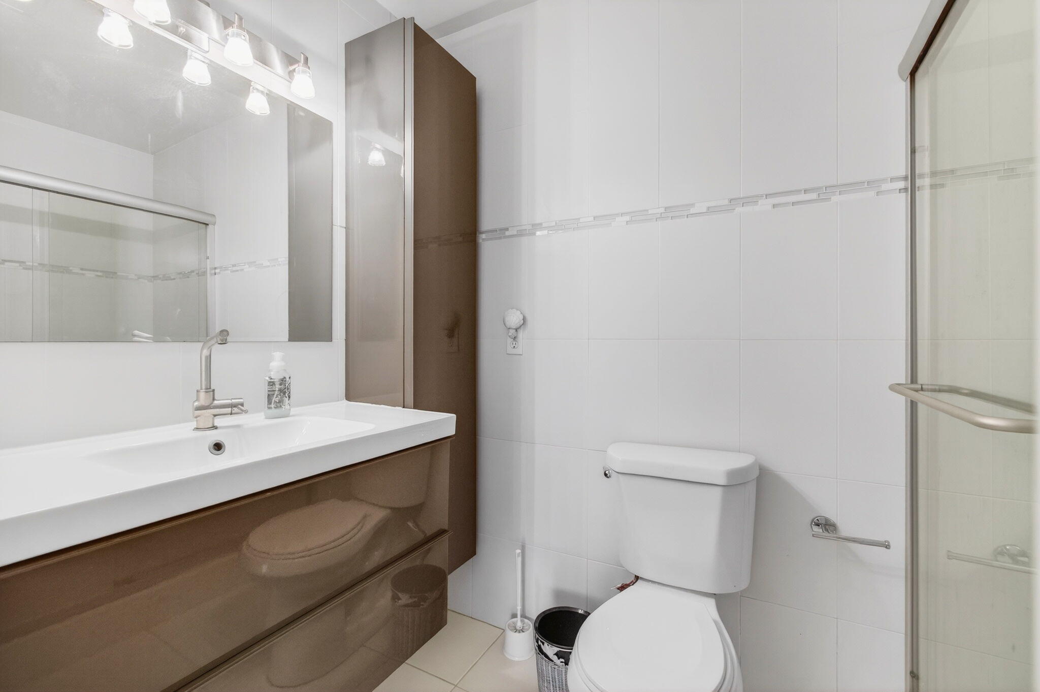 1327 High Point Way Southeast, Unit D Delray Beach, FL 33445 - Photo 29 of 53 a bathroom with a sink a toilet and shower