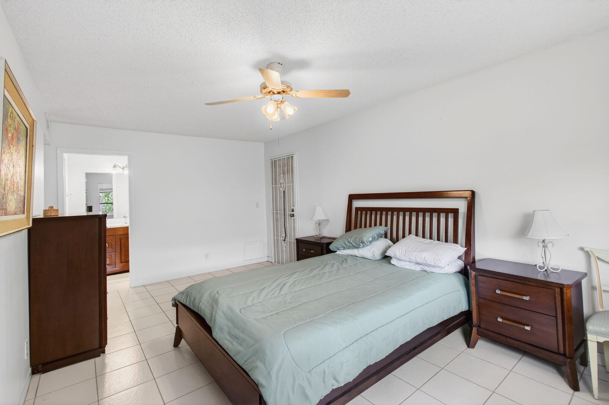 1327 High Point Way Southeast, Unit D Delray Beach, FL 33445 - Photo 30 of 53 a bedroom with a bed and wooden floor