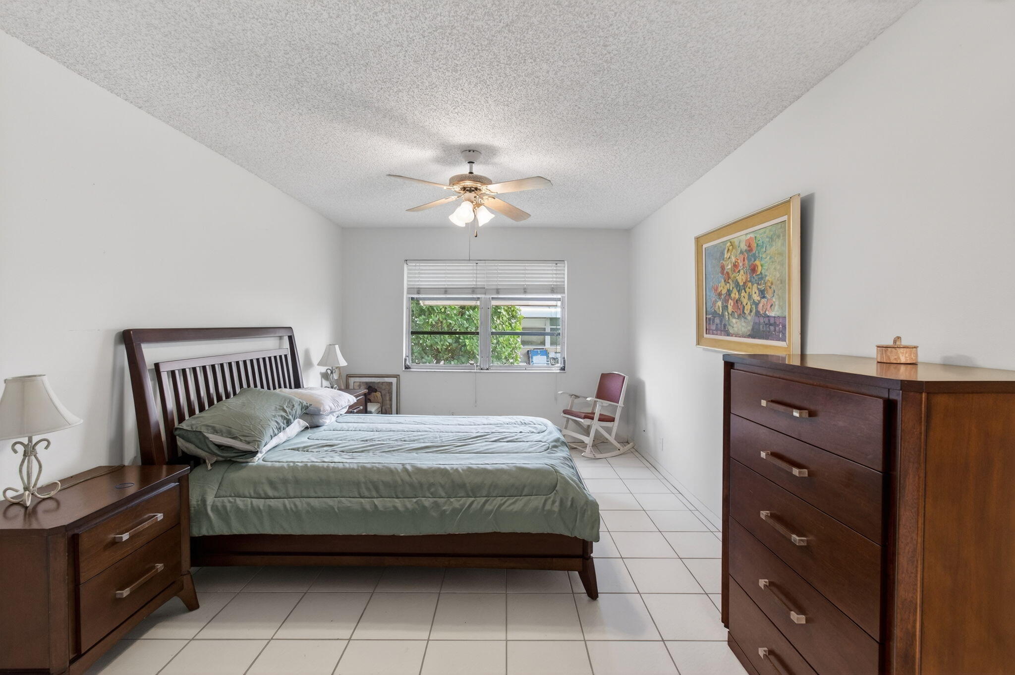 1327 High Point Way Southeast, Unit D Delray Beach, FL 33445 - Photo 31 of 53 a bedroom with a bed and a chandelier