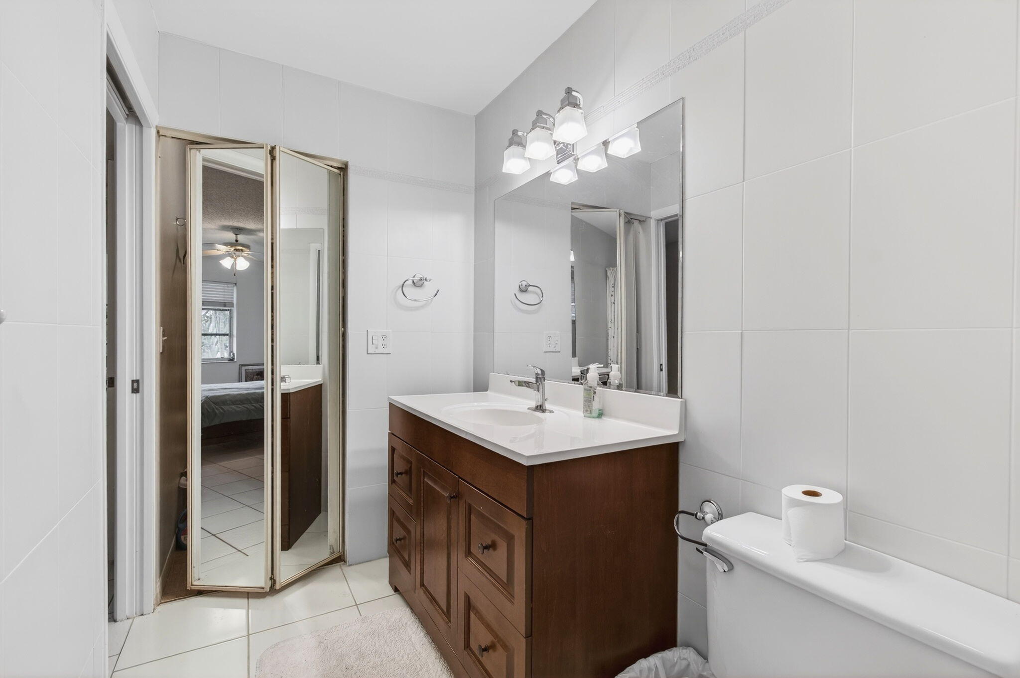 1327 High Point Way Southeast, Unit D Delray Beach, FL 33445 - Photo 32 of 53 a bathroom with a sink and a mirror