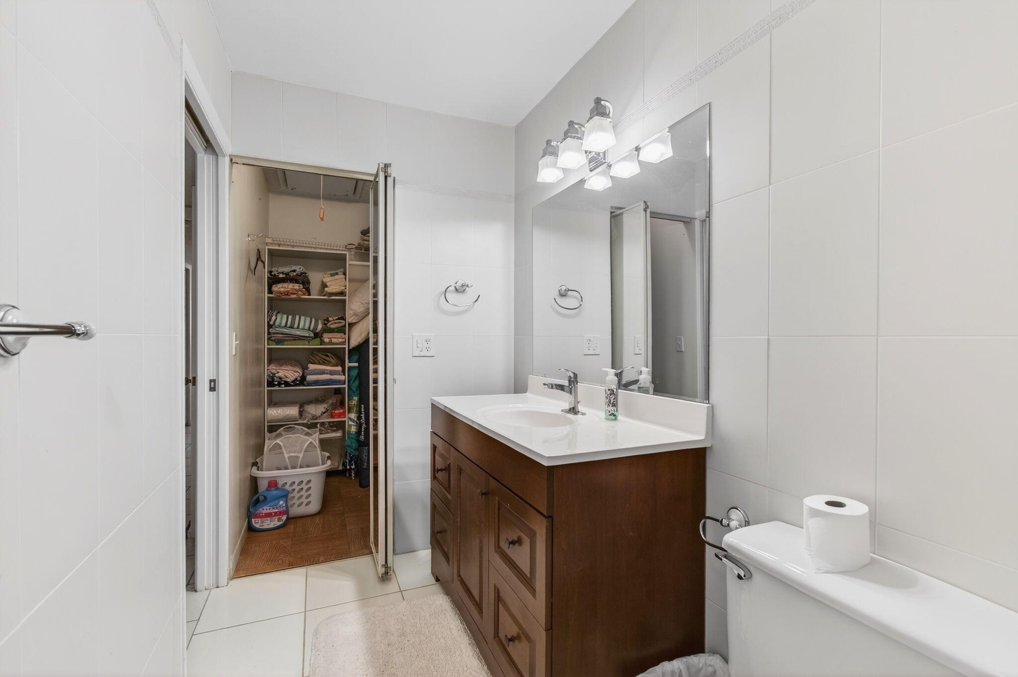 1327 High Point Way Southeast, Unit D Delray Beach, FL 33445 - Photo 33 of 53 a bathroom with a sink a vanity and a mirror