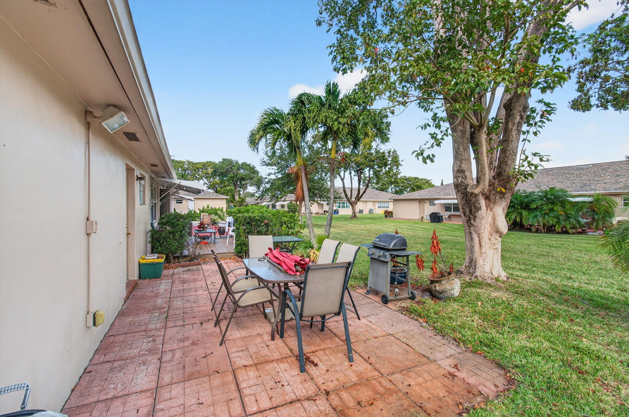 1327 High Point Way Southeast, Unit D Delray Beach, FL 33445 - Photo 36 of 53 a backyard of a house with table and chairs