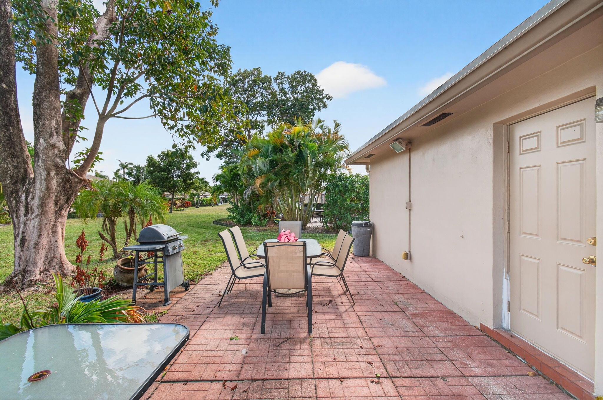 1327 High Point Way Southeast, Unit D Delray Beach, FL 33445 - Photo 38 of 53 a view of a chairs and table in backyard of the house