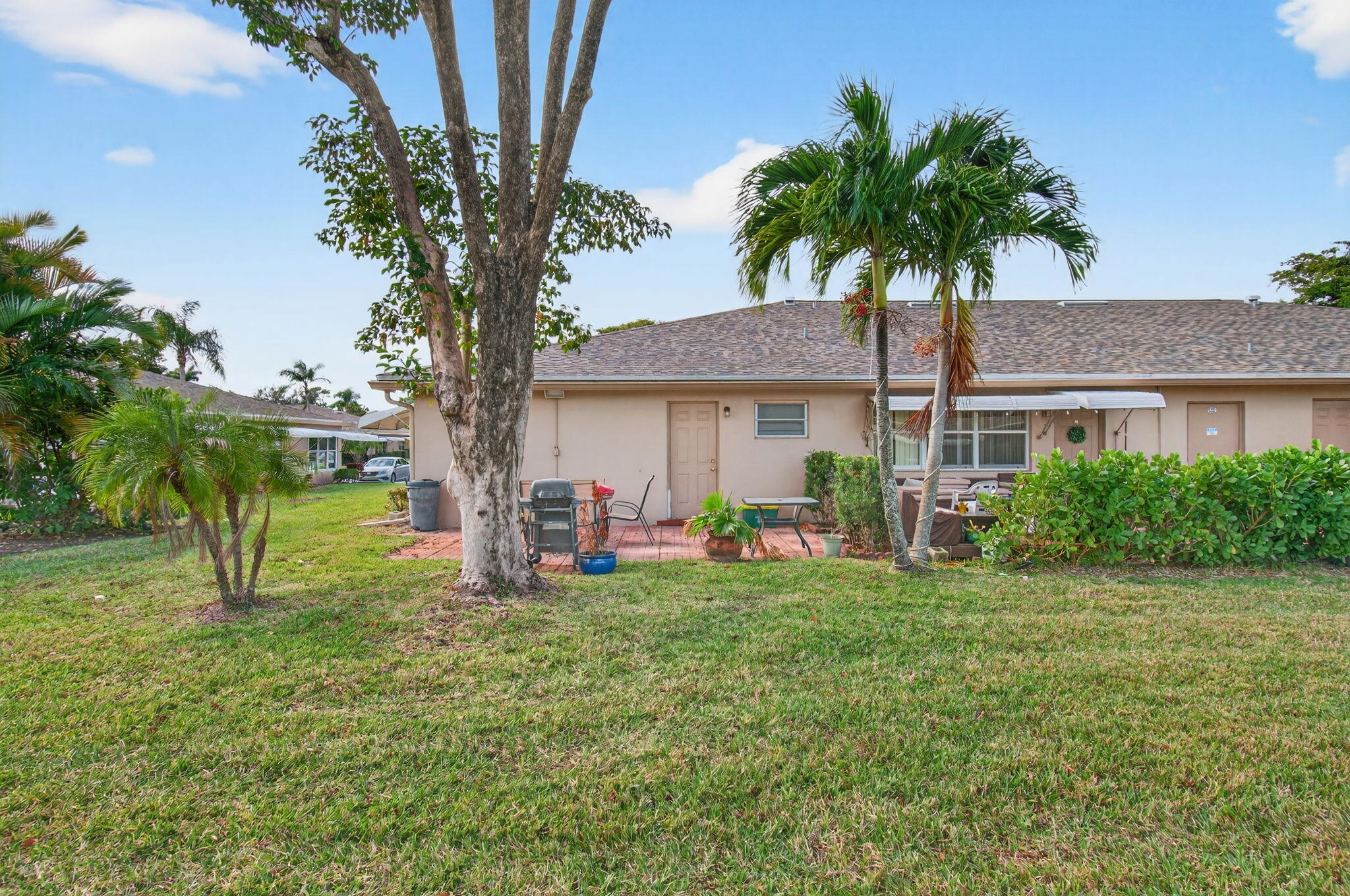 1327 High Point Way Southeast, Unit D Delray Beach, FL 33445 - Photo 40 of 53 a couple of table and chairs in the patio