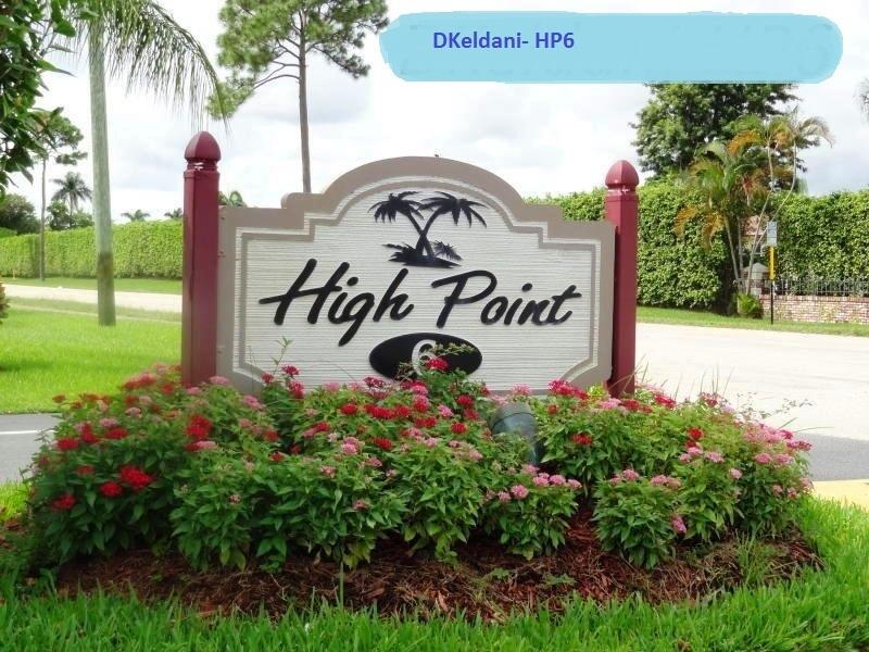 1327 High Point Way Southeast, Unit D Delray Beach, FL 33445 - Photo 41 of 53 a view of a sign board with flower around