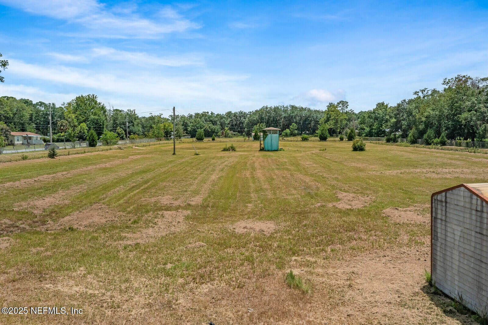 714 Jones Road Jacksonville, FL 32220 - Photo 8 of 12 a view of a field with an trees in the background