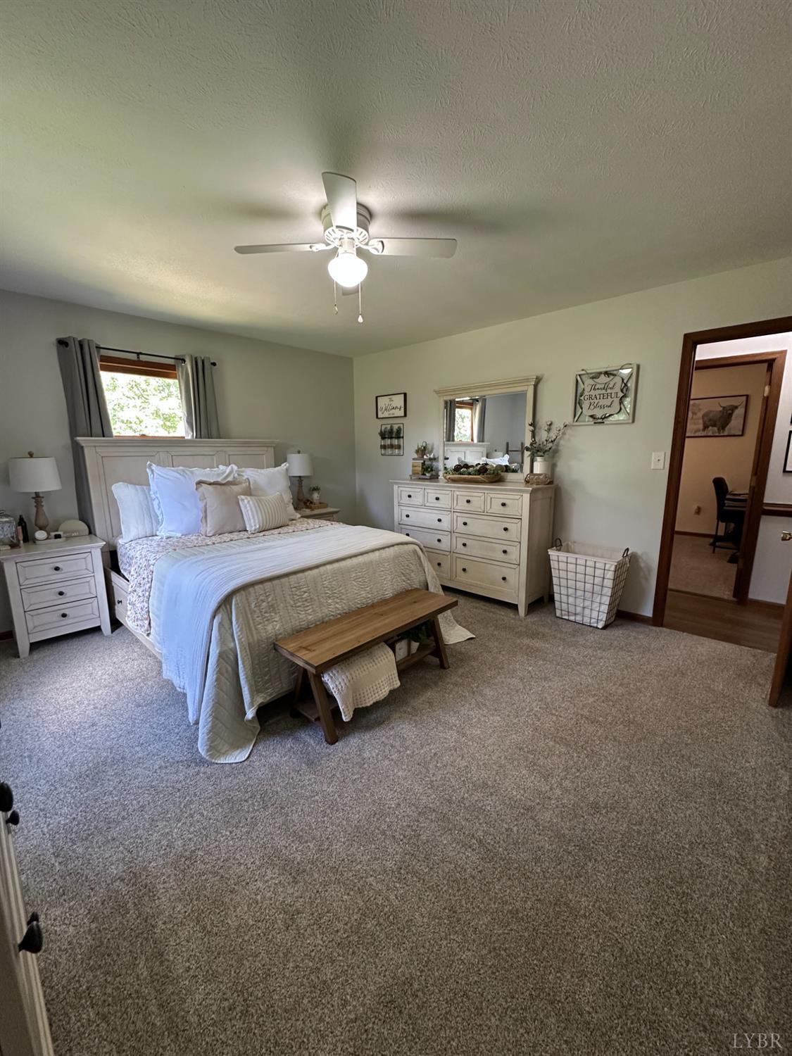 1524 Austin Road Gladstone, VA 24553 - Photo 12 of 30 a spacious bedroom with a bed and a chandelier