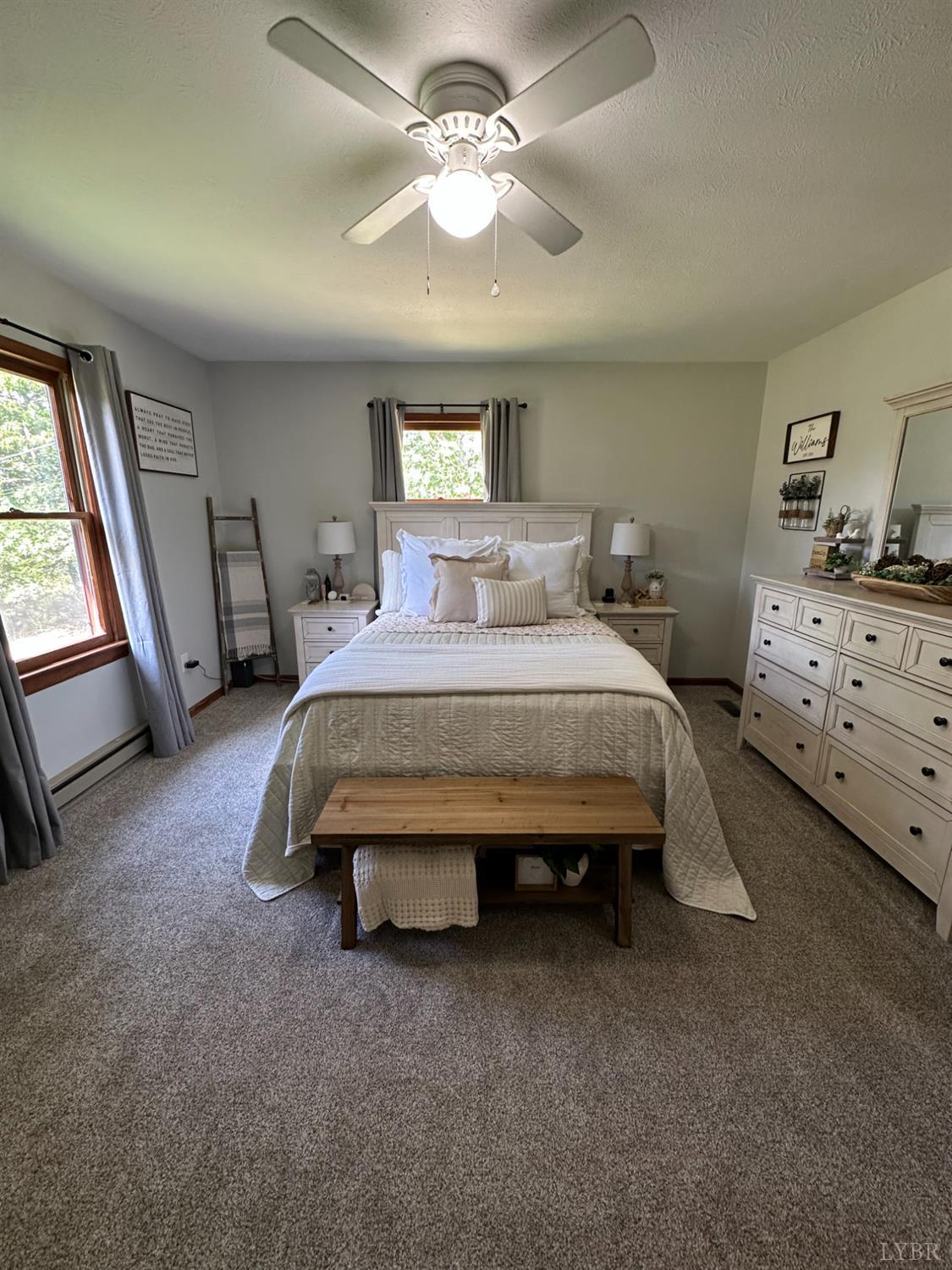 1524 Austin Road Gladstone, VA 24553 - Photo 14 of 30 a bedroom with a bed and a chandelier