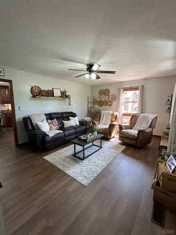 a living room with furniture and a wooden floor