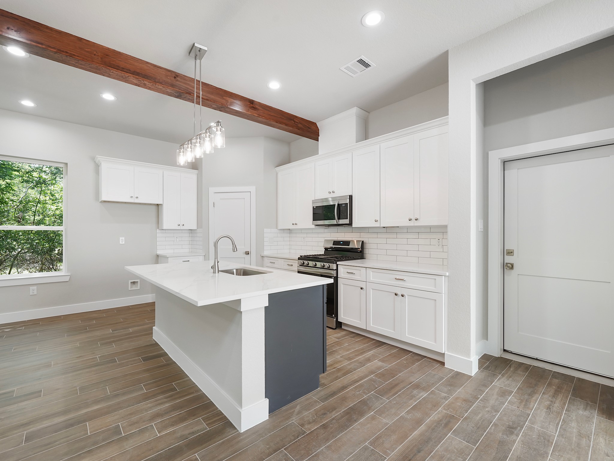 731 Magnolia Point Drive Houston, TX 77336 - Photo 11 of 36 a kitchen with appliances a sink and cabinets