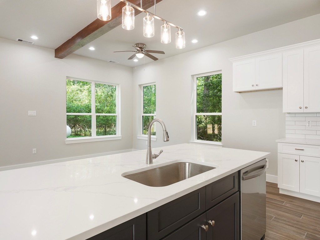 731 Magnolia Point Drive Houston, TX 77336 - Photo 12 of 35 a kitchen with a sink a window and cabinets