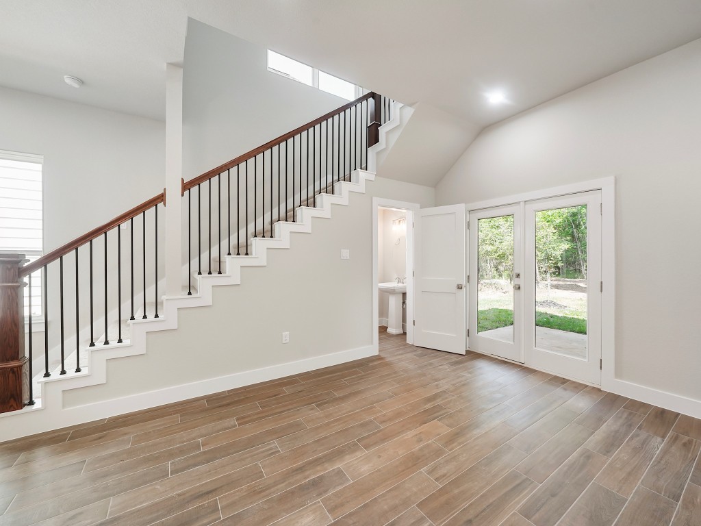 731 Magnolia Point Drive Houston, TX 77336 - Photo 17 of 36 an empty room with wooden floor and windows