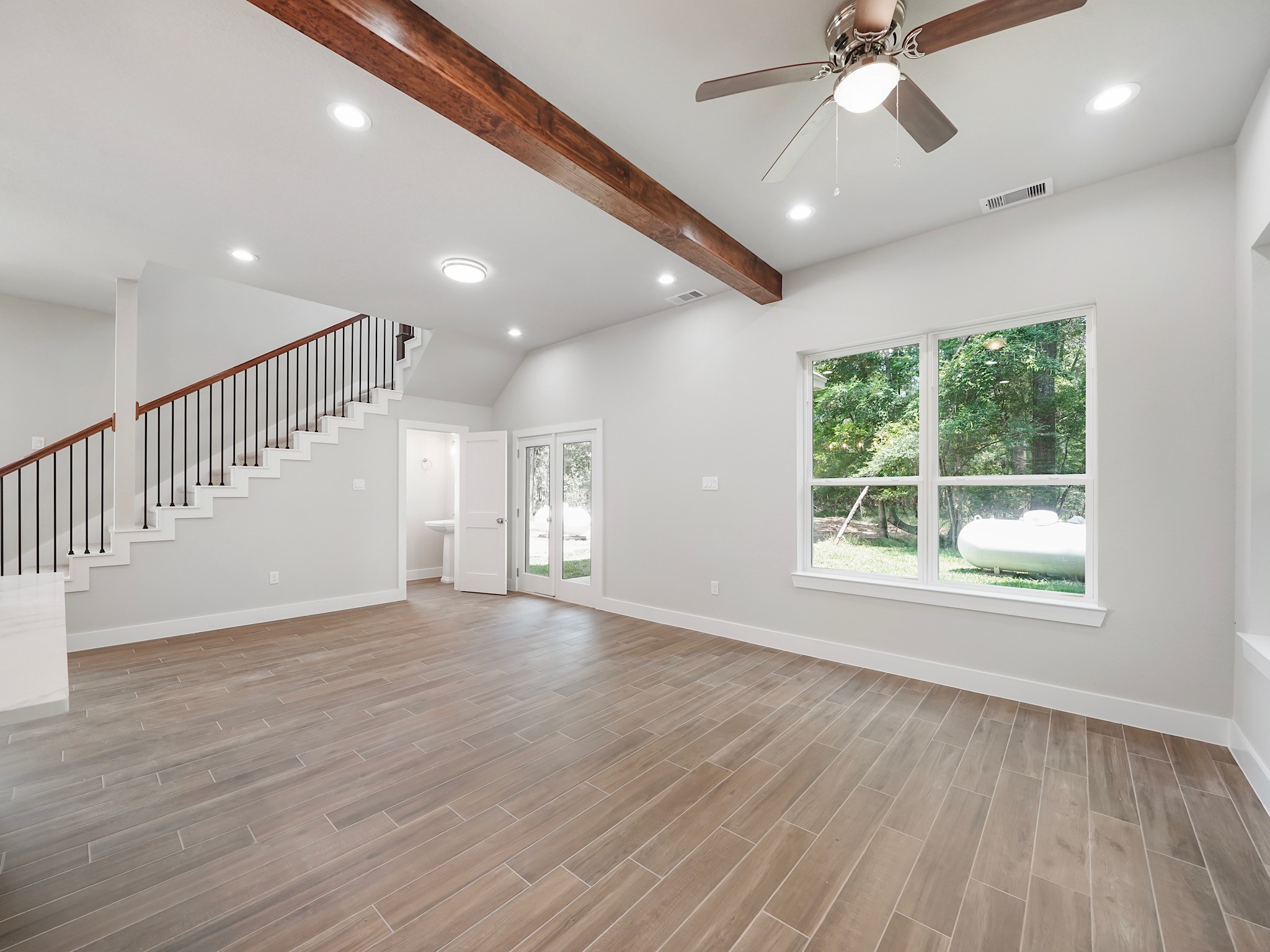 731 Magnolia Point Drive Houston, TX 77336 - Photo 19 of 36 a view of an empty room with wooden floor and a window