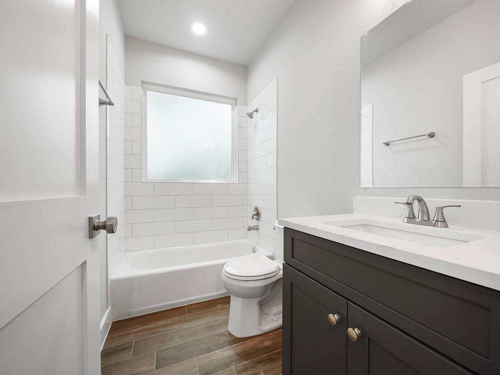 731 Magnolia Point Drive Houston, TX 77336 - Photo 26 of 35 a bathroom with a granite countertop sink toilet a large mirror a bathtub and shower