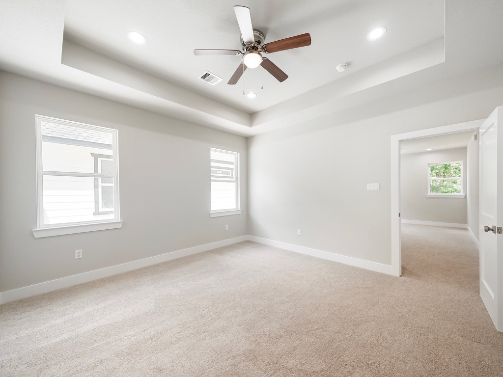 731 Magnolia Point Drive Houston, TX 77336 - Photo 27 of 35 en empty room with windows and ceiling fan