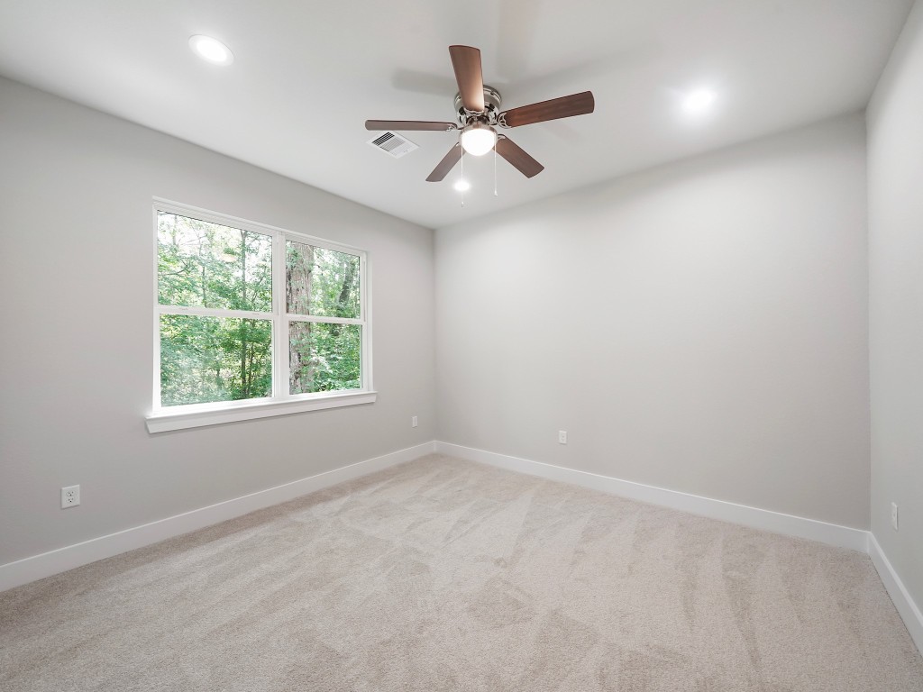 731 Magnolia Point Drive Houston, TX 77336 - Photo 29 of 35 an empty room with a window and a fan
