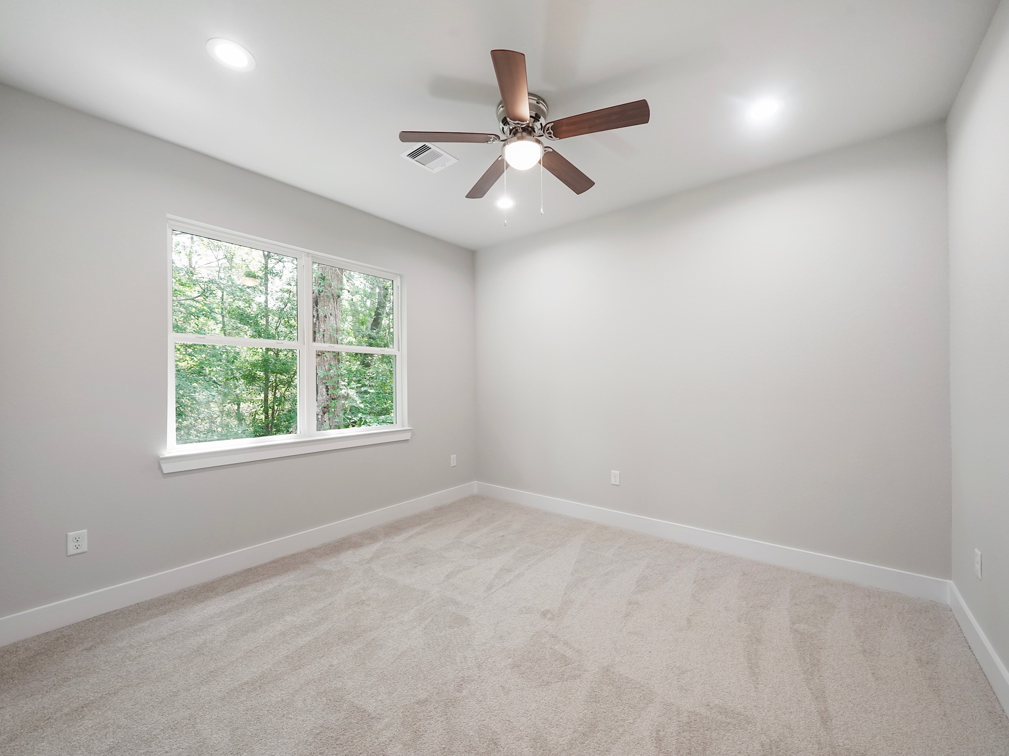 731 Magnolia Point Drive Houston, TX 77336 - Photo 30 of 36 an empty room with a window and a fan