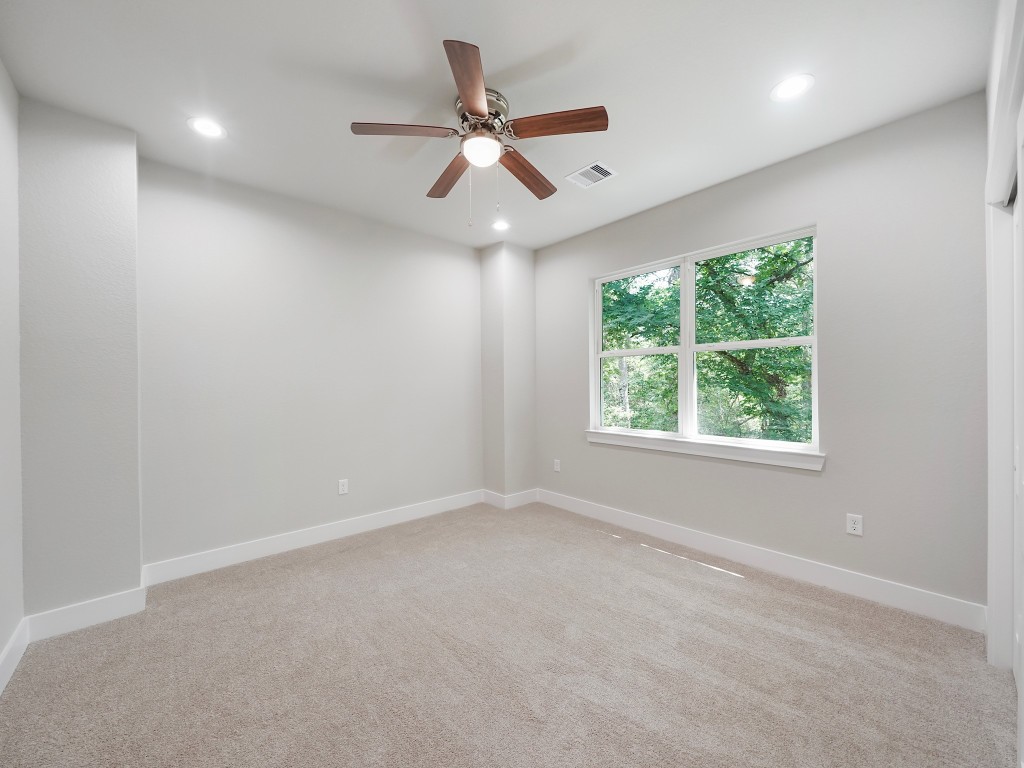 731 Magnolia Point Drive Houston, TX 77336 - Photo 32 of 35 an empty room with a window and a ceiling fan