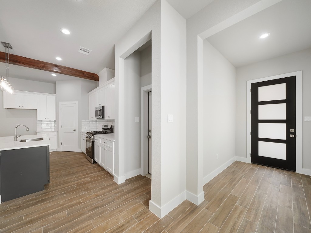 731 Magnolia Point Drive Houston, TX 77336 - Photo 6 of 35 a view of a kitchen with wooden floor and a window
