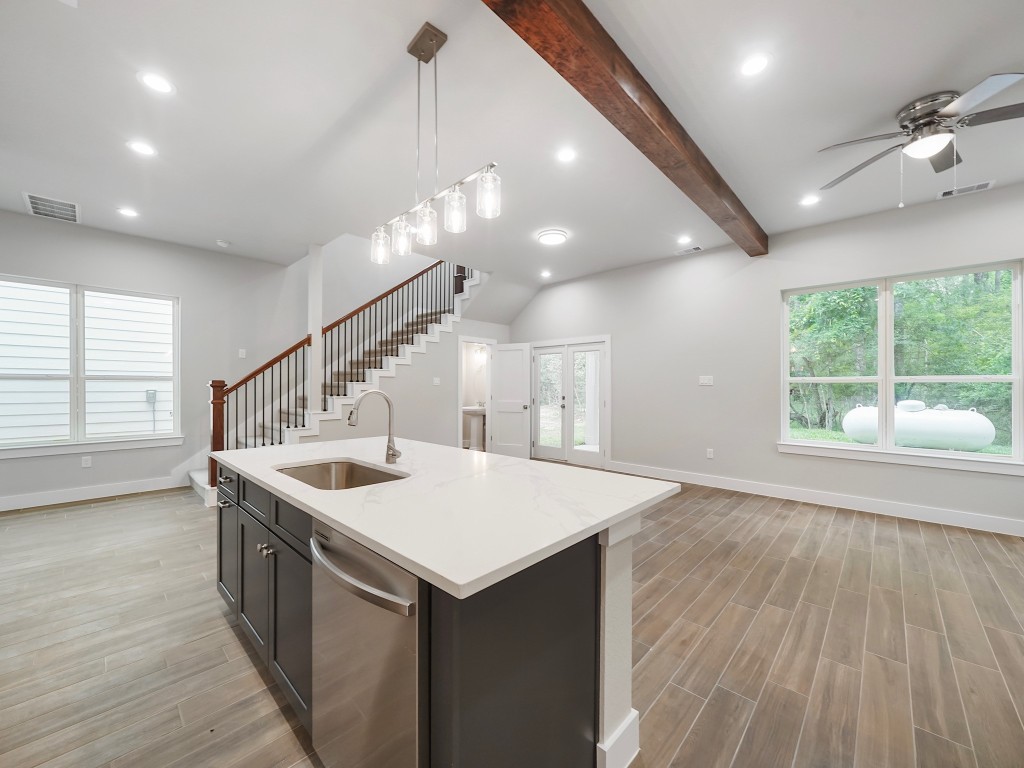 731 Magnolia Point Drive Houston, TX 77336 - Photo 9 of 35 a kitchen that has a sink a stove and wooden floor