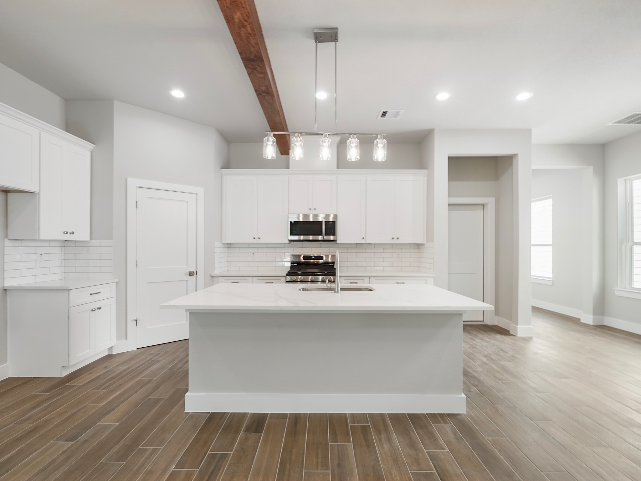 731 Magnolia Point Drive Houston, TX 77336 - Photo 9 of 36 a kitchen with kitchen island a sink and wooden floor