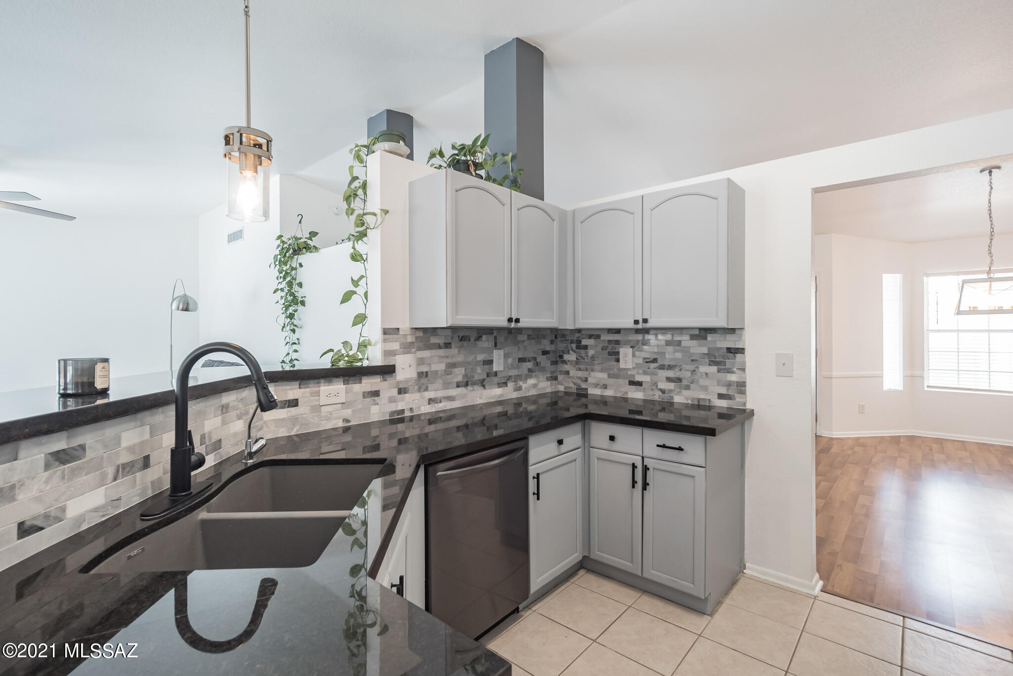 9671 East Azuma Way Tucson, AZ 85747 - Photo 5 of 31 a kitchen with a sink and cabinets