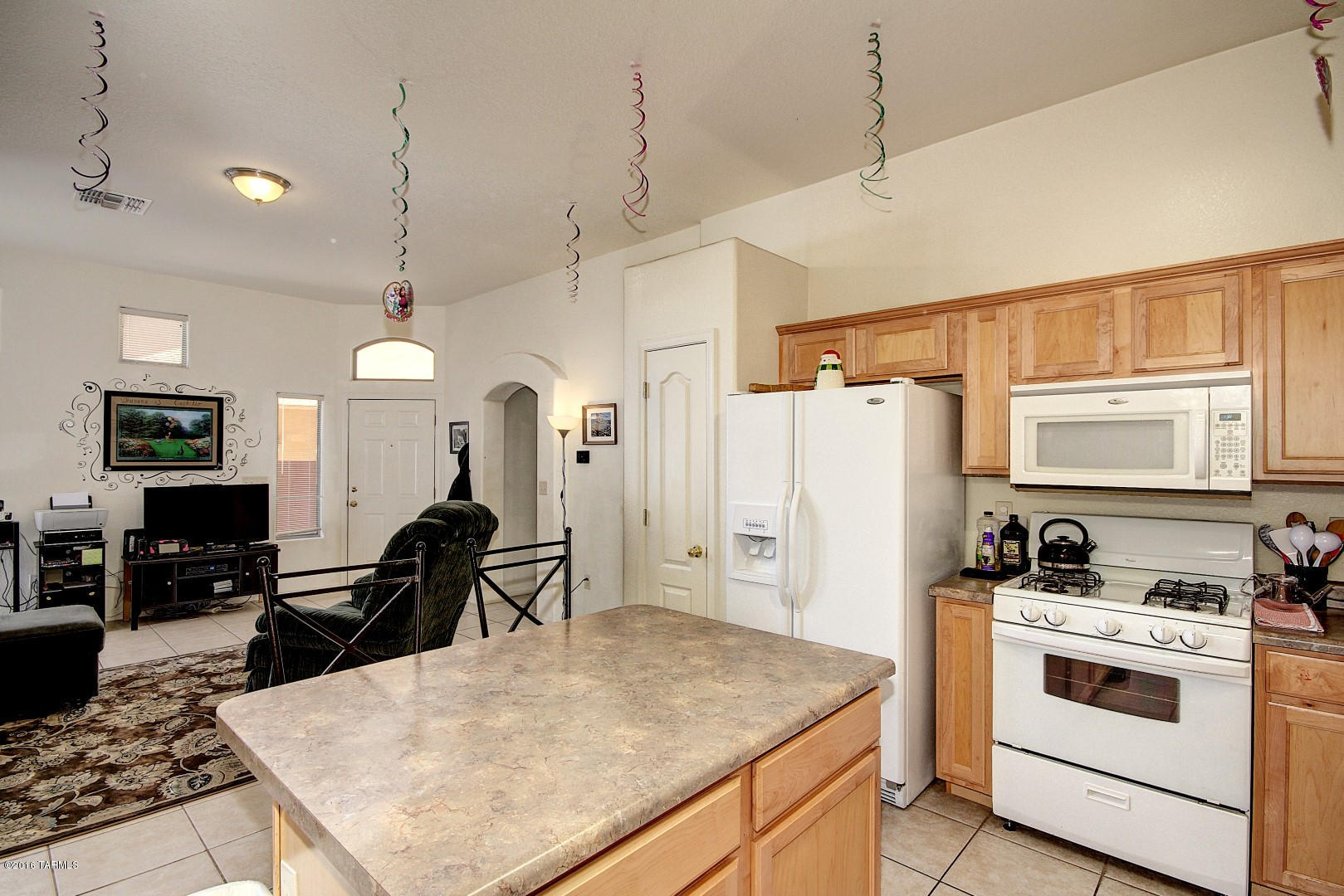6016 South Avenida Ribero Tucson, AZ 85706 - Photo 7 of 15 a kitchen with a table chairs refrigerator and cabinets