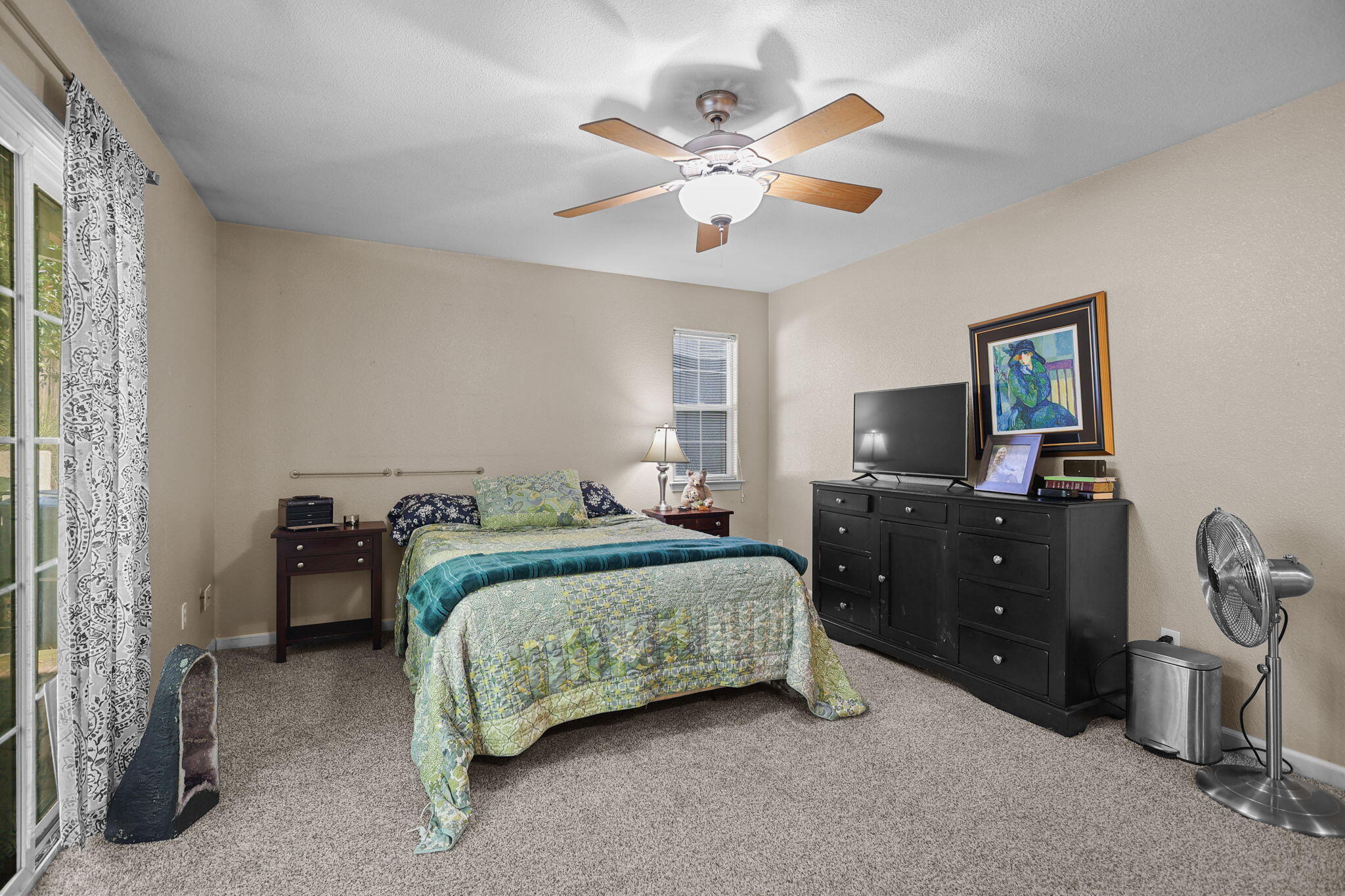 720 Stonebriar Trail Redding, CA 96003 - Photo 15 of 19 a bedroom with a bed and a chandelier