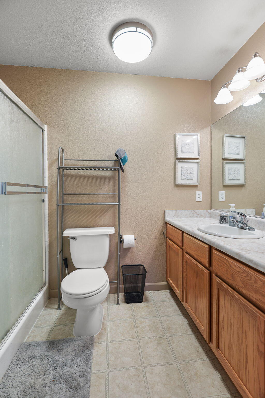 720 Stonebriar Trail Redding, CA 96003 - Photo 17 of 19 a bathroom with a granite countertop toilet sink and mirror